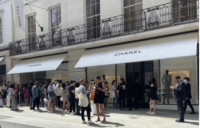 Shoppers Queue Outside Chanel Store On Editorial Stock Photo