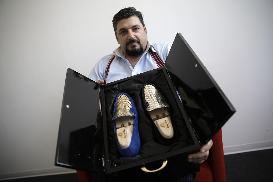 Italian shoe master sews shoes in gold