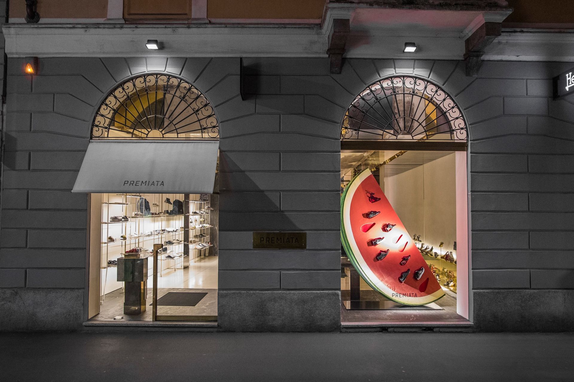 Premiata Milan shoe store showcase in Milan with evening lighting